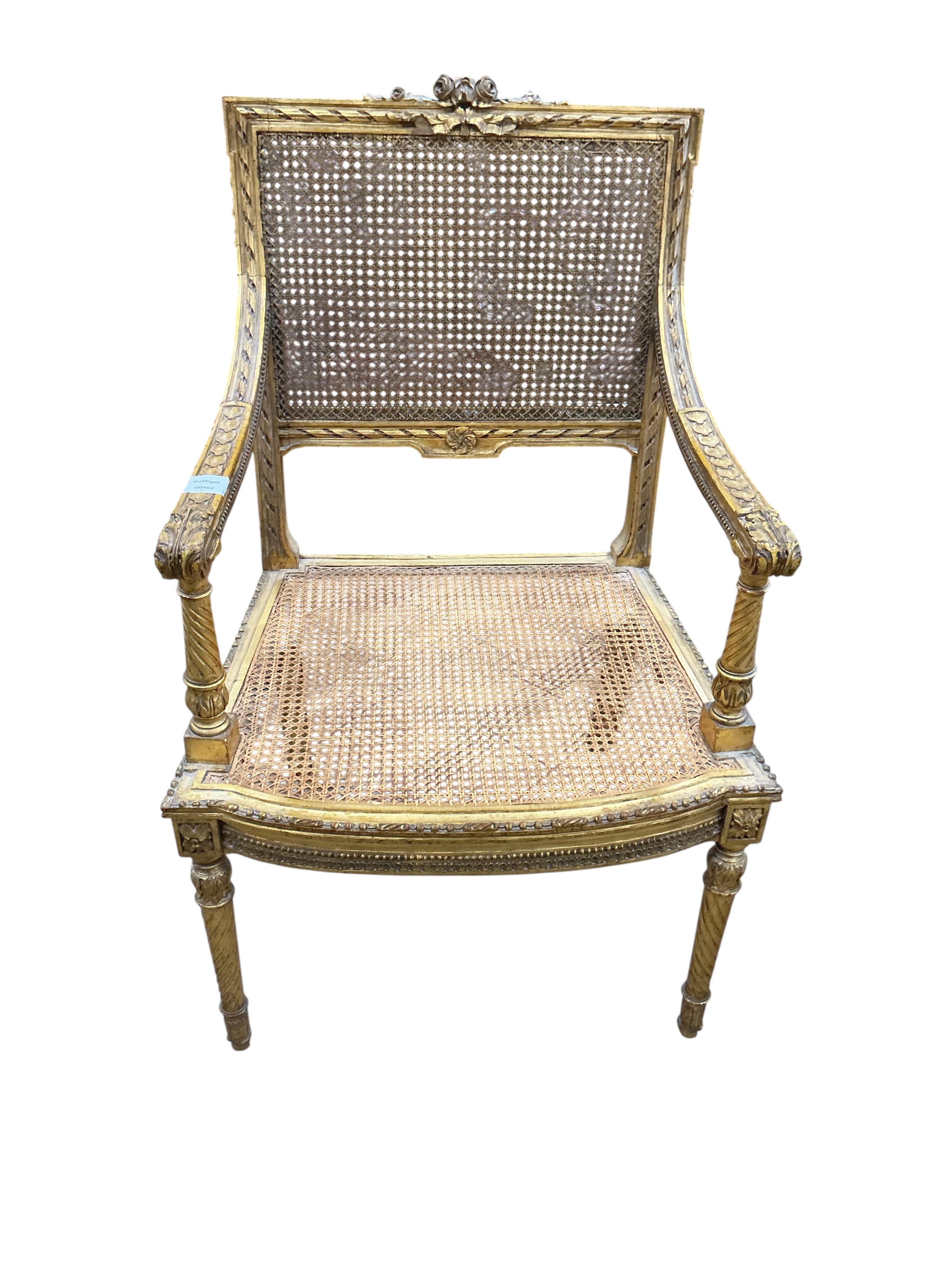 A late 19th century French Louis XVI style open elbow chair with cane seat, a matching side chair and another giltwood side chair